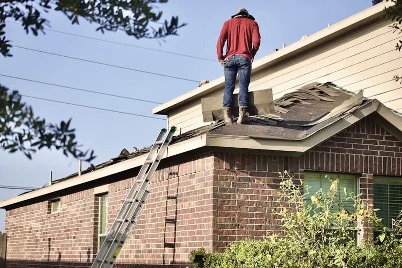 Professional roofer working on a residential roof in Cato